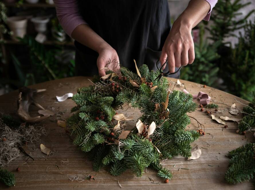 Woman making Christmas wreath of spruce, step by step.